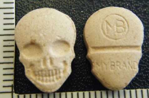 Image showing MDMA/Ecstasy tablet called Yellow MyBrand Skulls